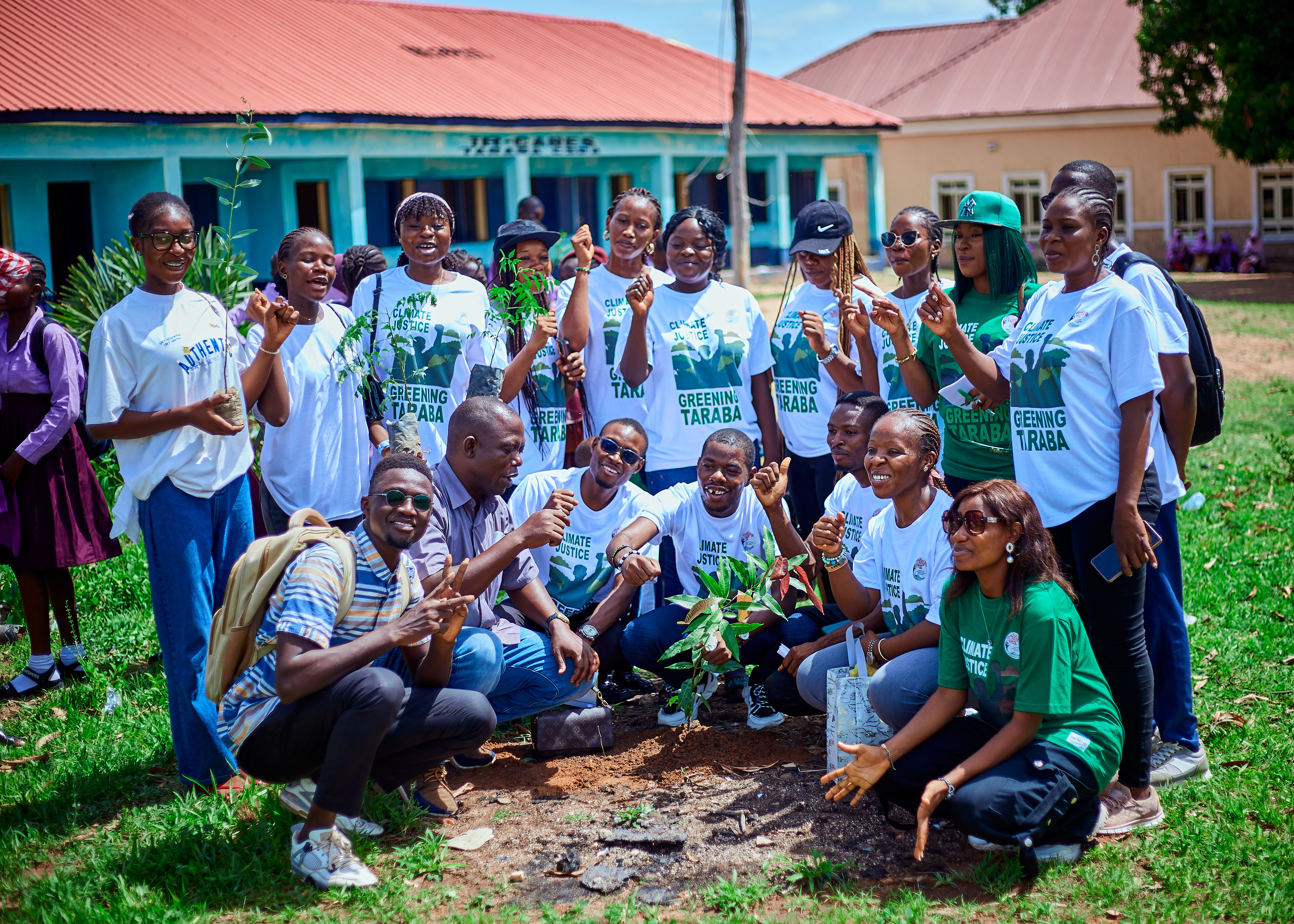 Community volunteers planting a young tree